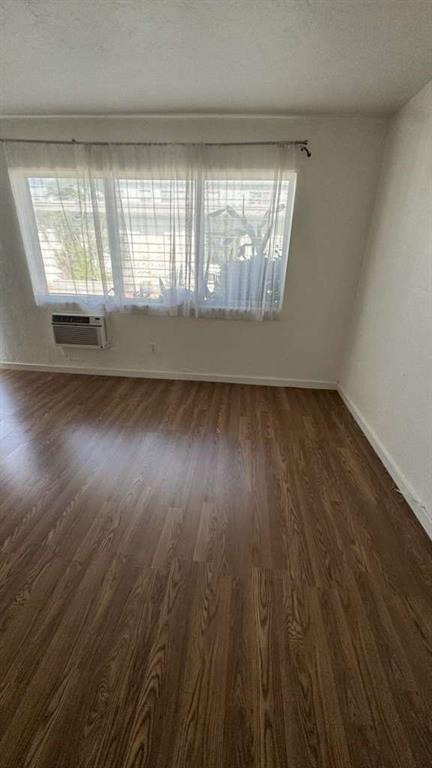 750 83rd Street, Unit 3 Miami Beach, FL 33141 - Photo 8 of 31 an empty room with wooden floor and windows