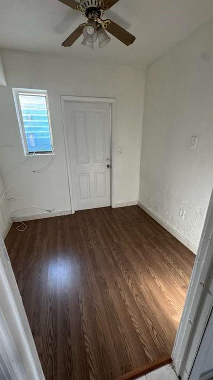 750 83rd Street, Unit 3 Miami Beach, FL 33141 - Photo 9 of 31 en empty room with wooden floor fan and windows