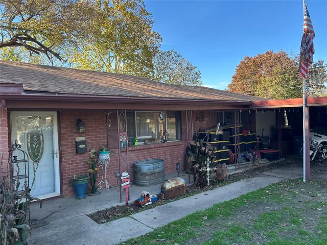 a side of a brick house with a canopy over it