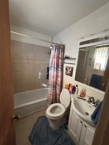 a bedroom with a bed window and walk in closet