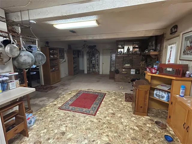 a living room with furniture a dining table and a fireplace