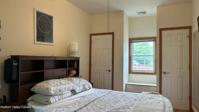 a bedroom with a bed and a window