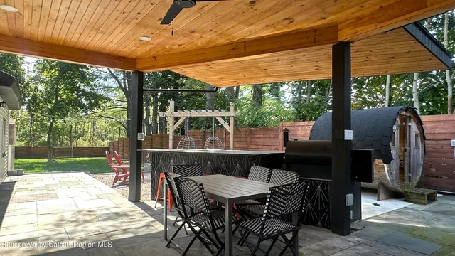 a view of a patio with a table chairs and a yard