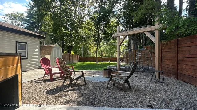 a view of a sitting area with chairs and wooden fence