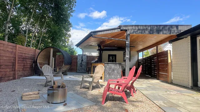 a patio with table and chairs and potted plants