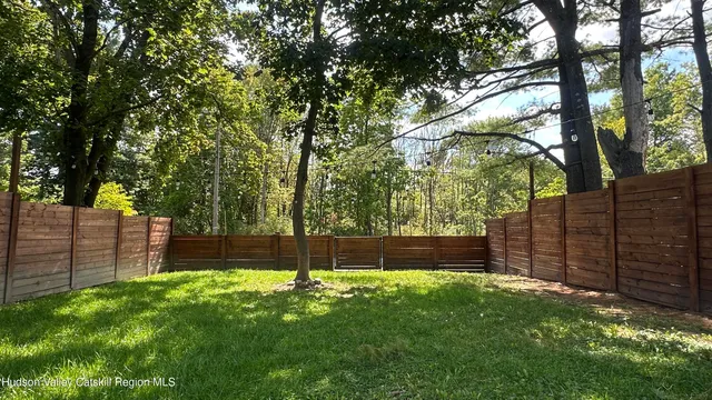 a view of a backyard with a large tree