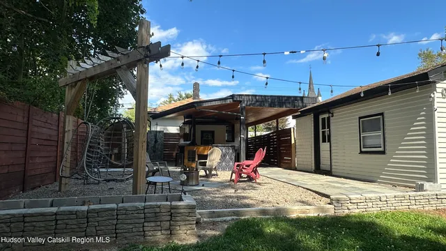 a view of a patio with a table and chairs under an umbrella