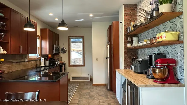 a kitchen with stainless steel appliances granite countertop a stove and cabinets