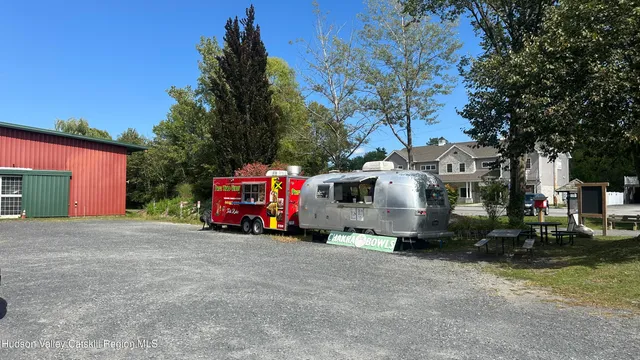 a view of a fire pit with large trees