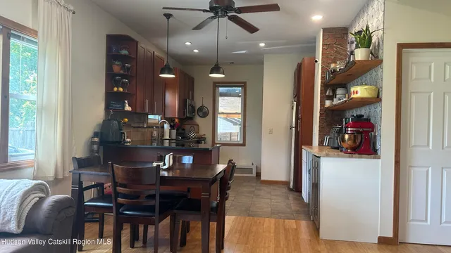a view of a dining room with furniture and wooden floor