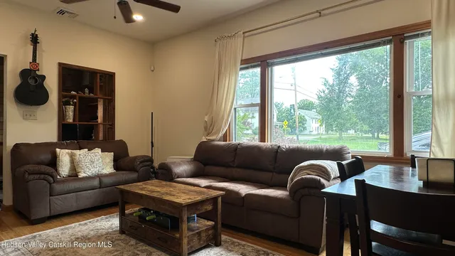 a living room with furniture and a large window