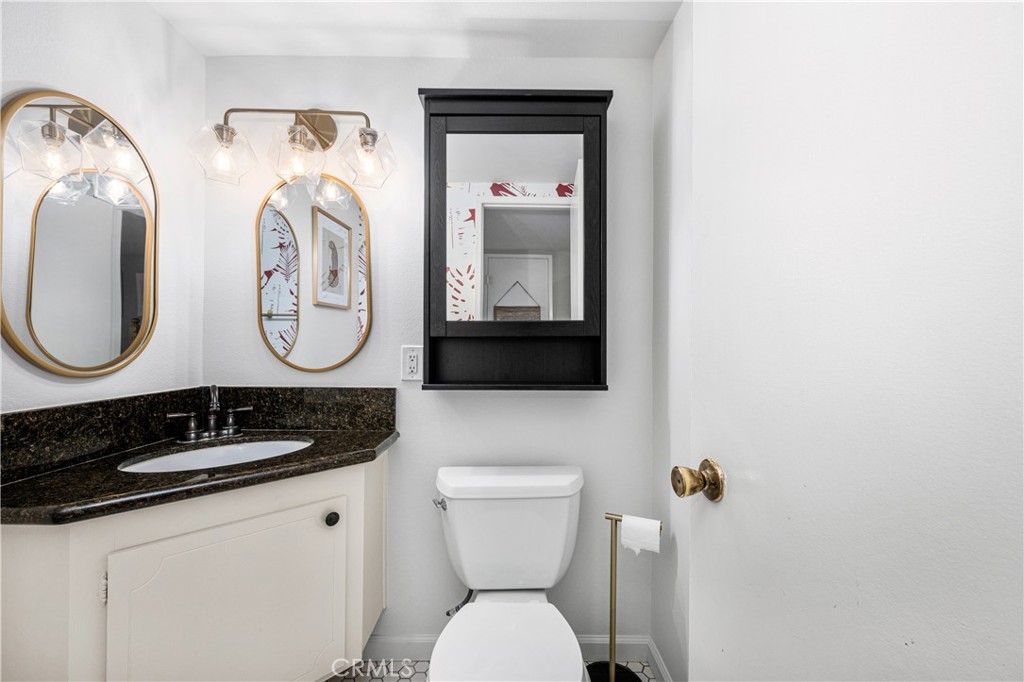 4237 Larwin Avenue Cypress, CA 90630 - Photo 20 of 48 a bathroom with a toilet a sink and mirror