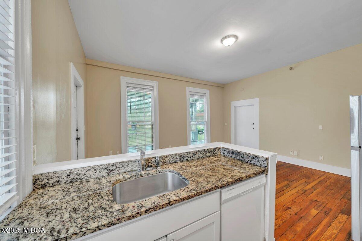 1873 Hardeman Avenue Macon, GA 31201 - Photo 13 of 25 a bathroom with a granite countertop sink and a mirror