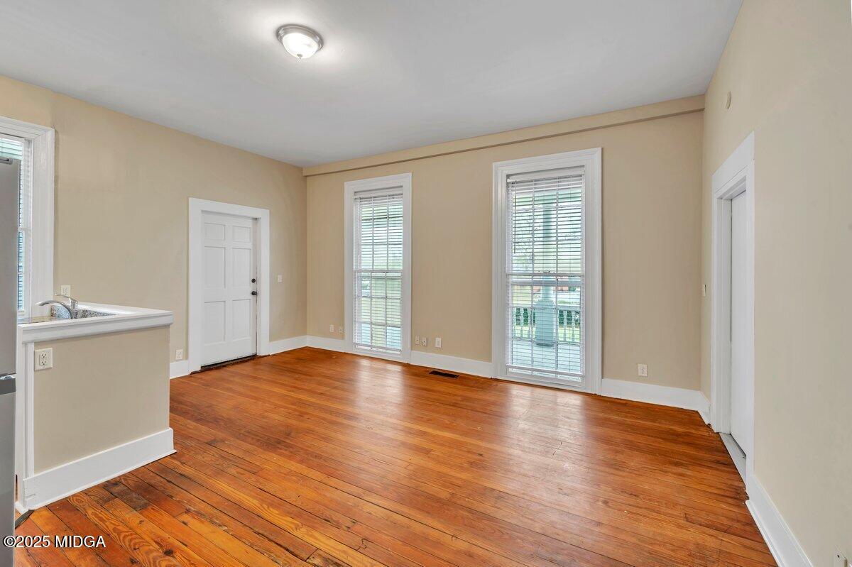 1873 Hardeman Avenue Macon, GA 31201 - Photo 14 of 25 a view of an empty room with window and wooden floor