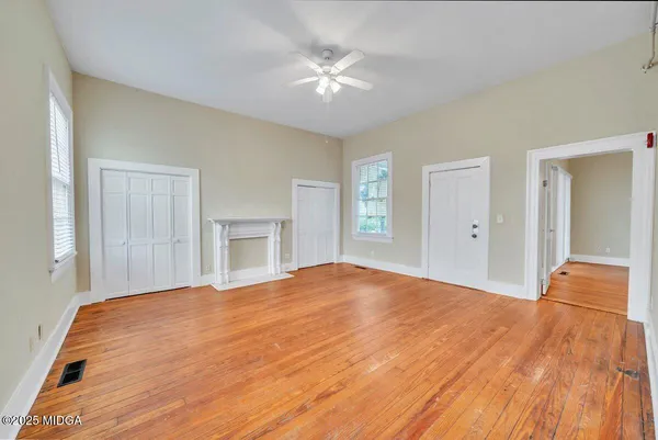 a big room with closet and a ceiling fan
