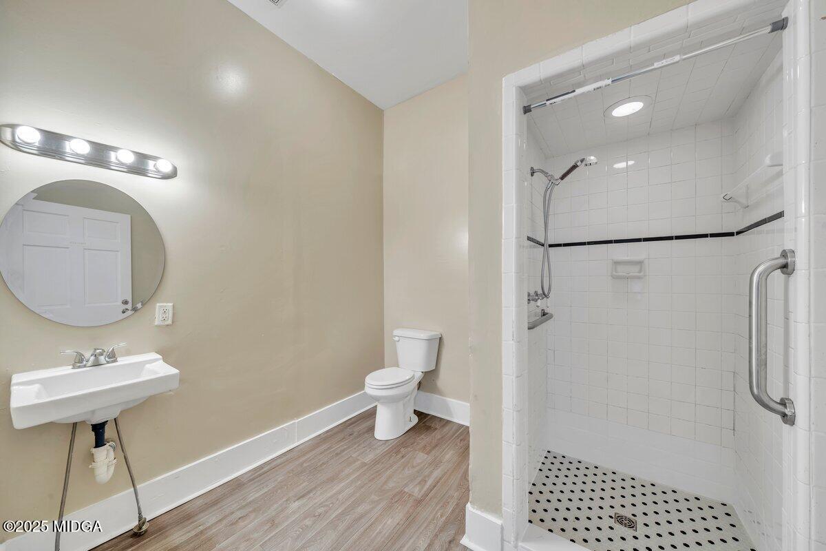 1873 Hardeman Avenue Macon, GA 31201 - Photo 16 of 25 a bathroom with a sink a toilet a shower and a mirror