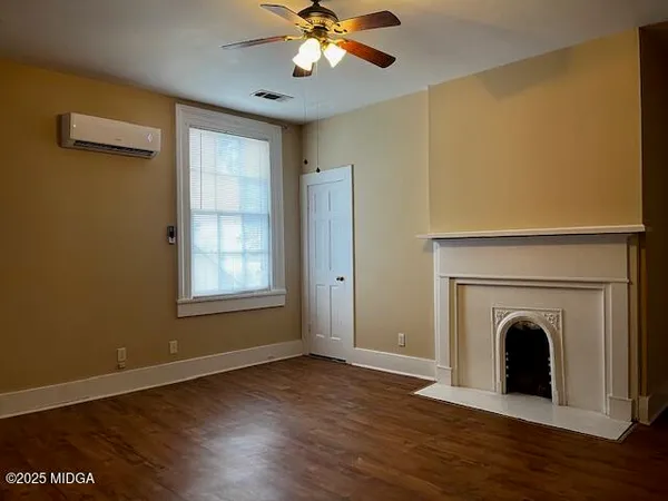 a view of a livingroom with a fireplace and wooden floor