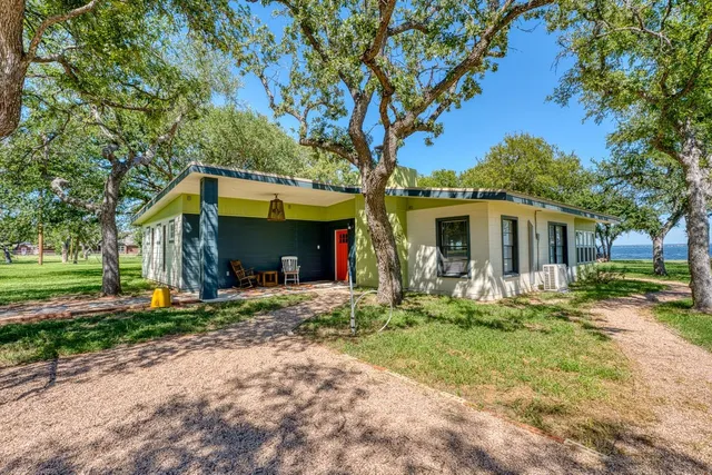 a front view of a house with a yard and porch