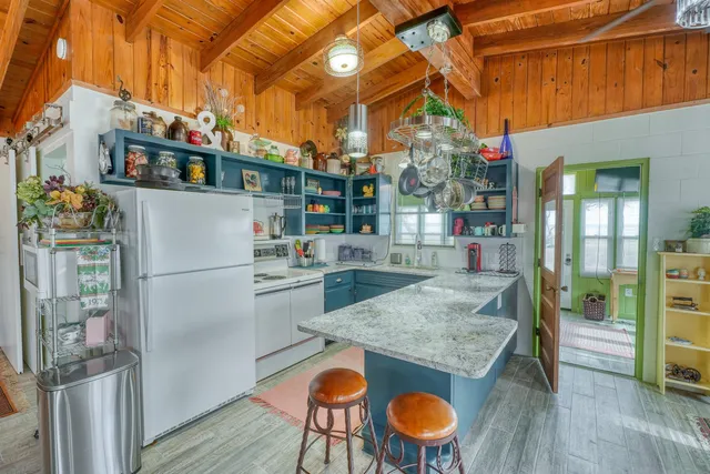 a kitchen with stainless steel appliances granite countertop a refrigerator and a stove