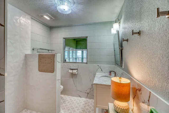a bathroom with a sink toilet and shower
