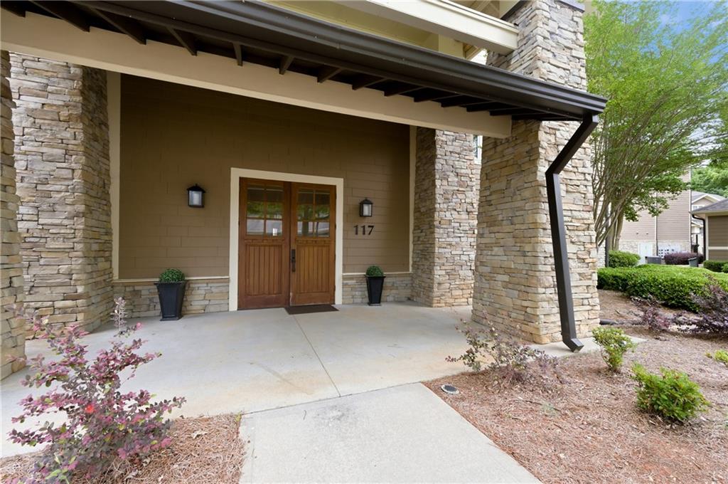 117 South Bay Road, Unit 402 Eatonton, GA 31024 - Photo 43 of 48 a front view of a house with parking