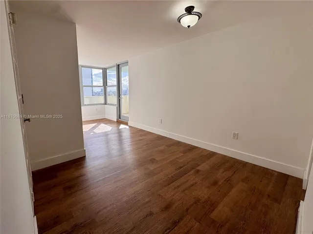 a kitchen with white cabinets stainless steel appliances and sink