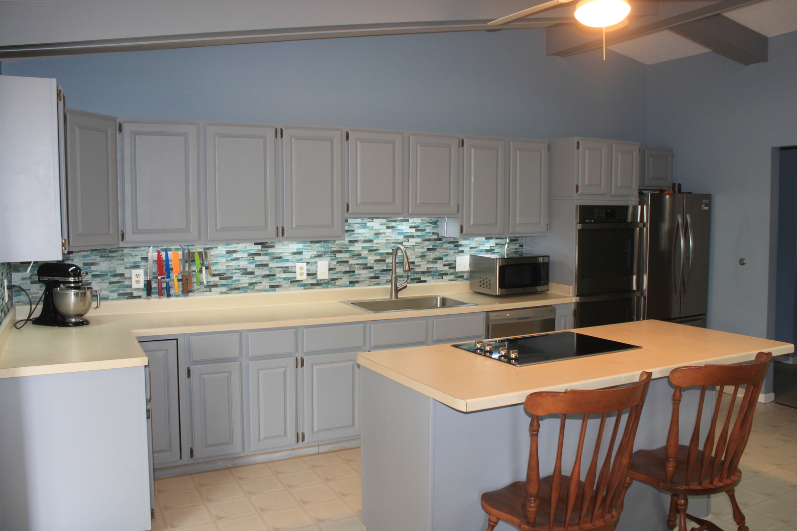 12892 Lawrence Road Sterling, IL 61081 - Photo 2 of 29 a kitchen with stainless steel appliances kitchen island a table chairs in it and wooden floors