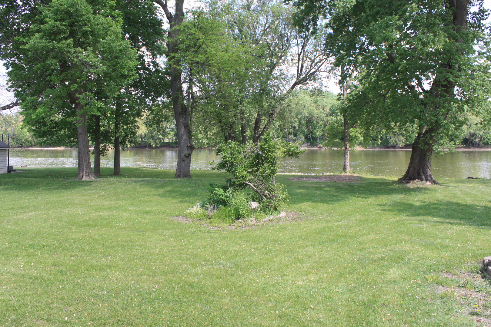 12892 Lawrence Road Sterling, IL 61081 - Photo 21 of 29 a backyard of a house with lots of green space and fountain