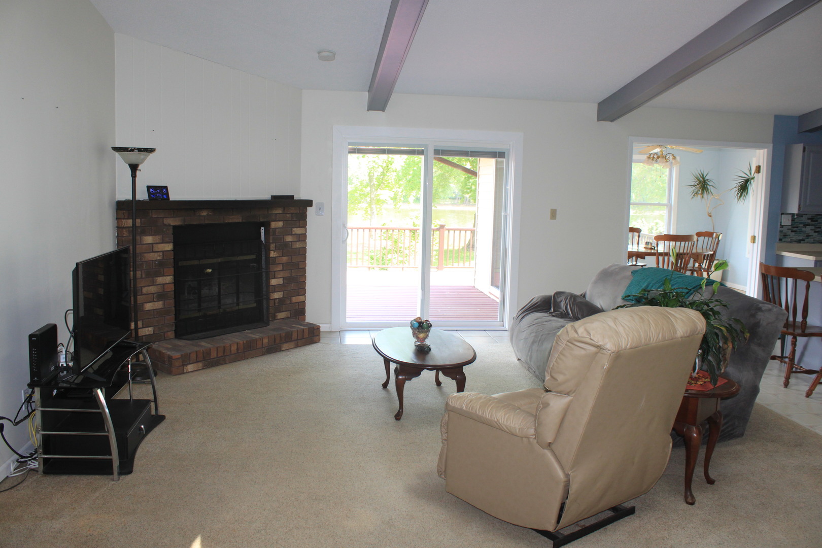 12892 Lawrence Road Sterling, IL 61081 - Photo 4 of 29 a living room with furniture a fireplace and a window