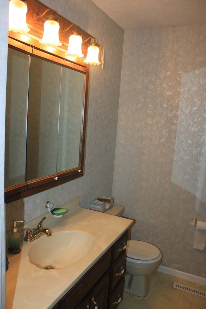 12892 Lawrence Road Sterling, IL 61081 - Photo 7 of 29 a bathroom with a sink and a toilet