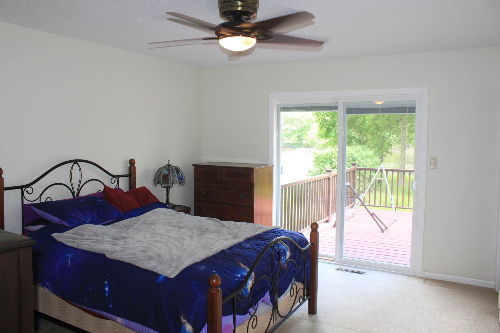 12892 Lawrence Road Sterling, IL 61081 - Photo 8 of 29 a bedroom with a bed and a table with lamp