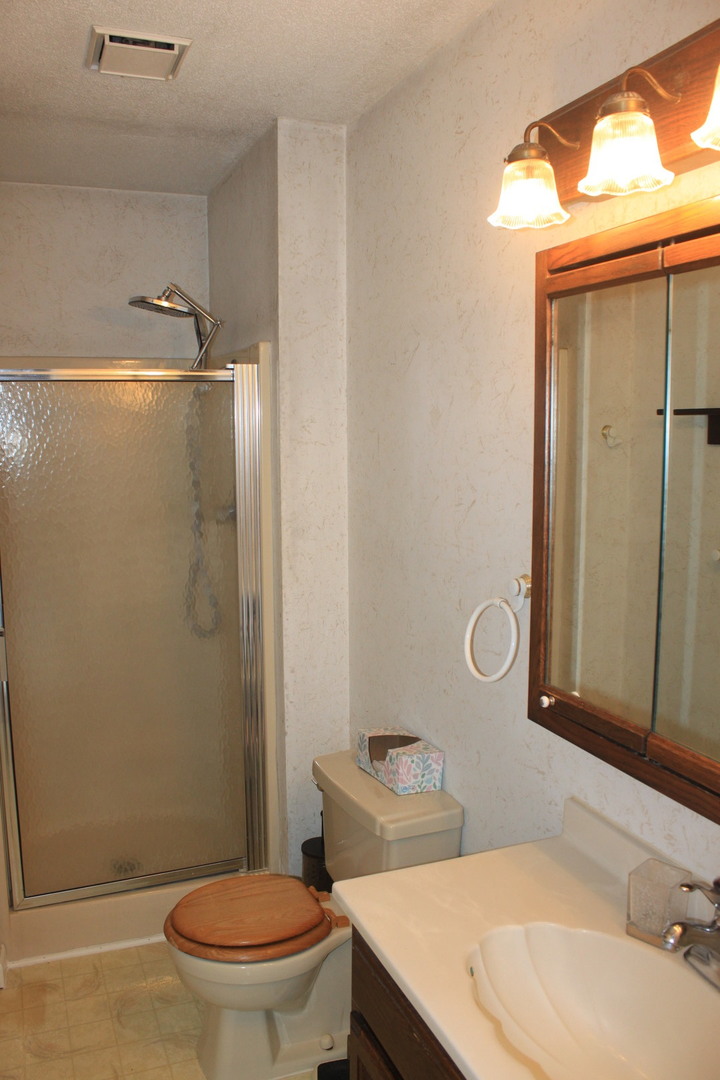 12892 Lawrence Road Sterling, IL 61081 - Photo 9 of 29 a bathroom with a sink a toilet and shower