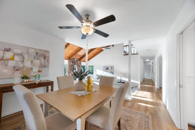 a view of a dining room with furniture and wooden floor