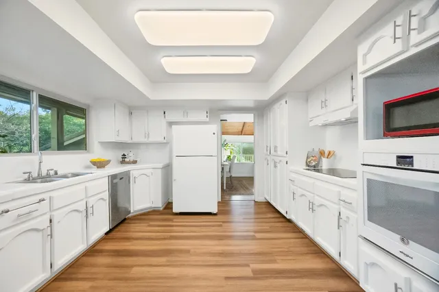 a kitchen with a sink and a refrigerator