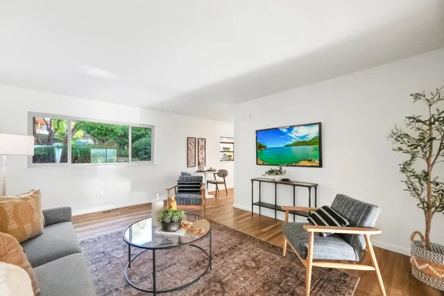 a bedroom with furniture and a large window