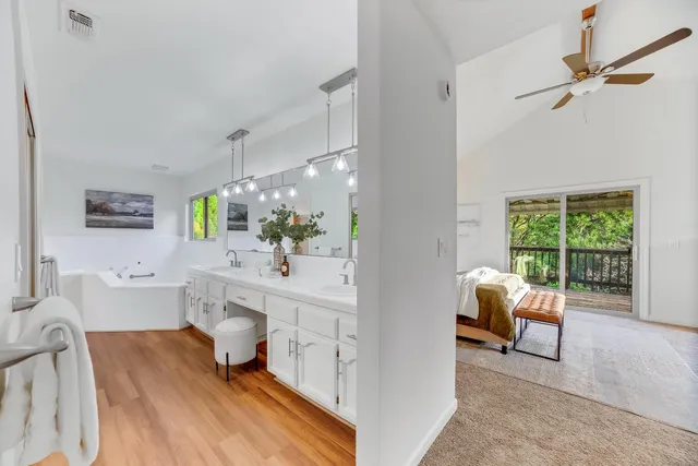 a bathroom with a sink a large mirror and a bathtub