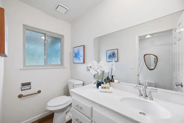 an aerial view of a house with a yard and balcony