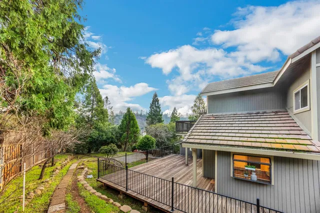 a view of a house with wooden bridge