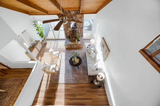 a living room with furniture and a ceiling fan