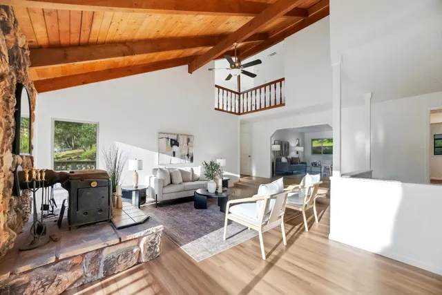 a porch with a bench next to a yard