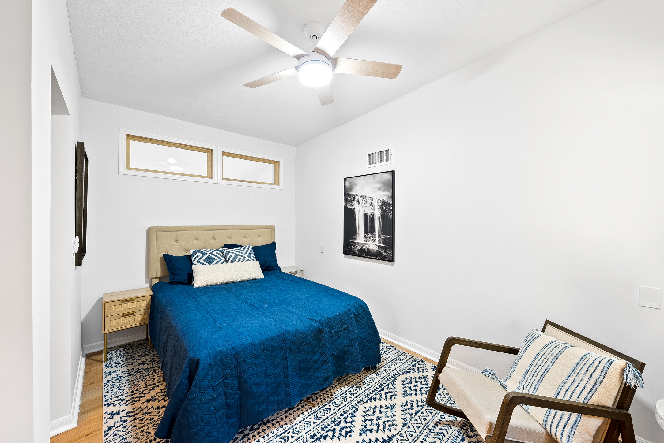 16811 South Ridge Lane Austin, TX 78734 - Photo 15 of 24 A comforting bedroom features a ceiling fan, a stylish rug, and warm wooden flooring.