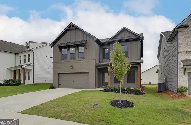 a front view of a house with a yard and garage