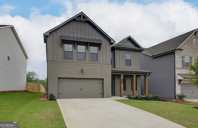 a front view of a house with a yard and garage