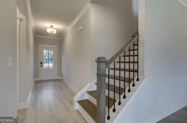 a view of an entryway with wooden floor
