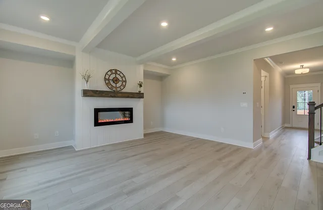 a view of an empty room and wooden floor