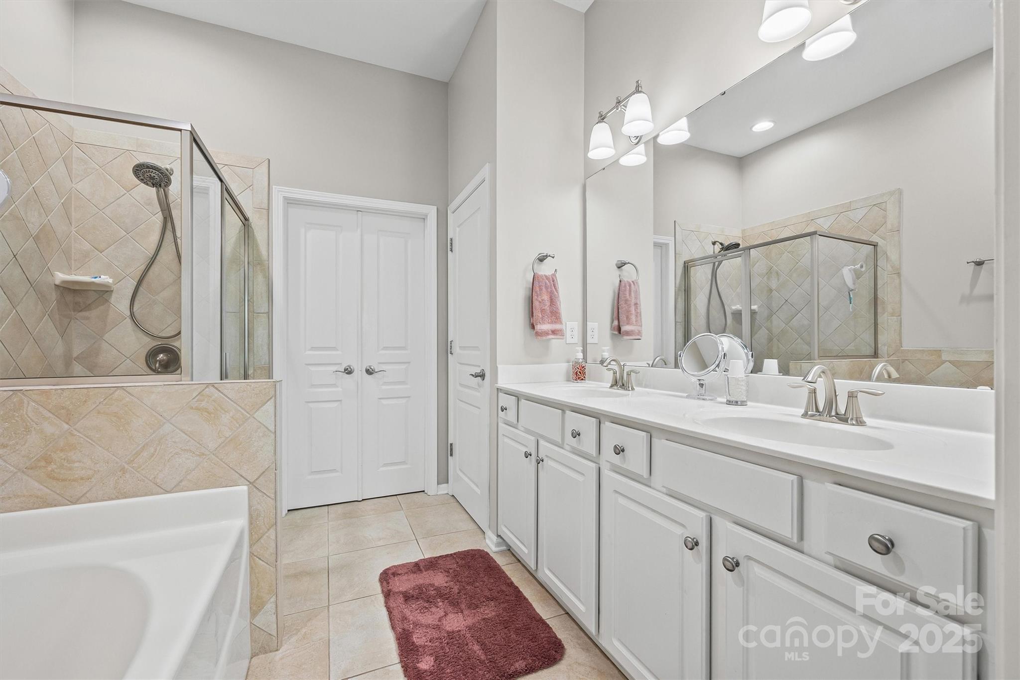 2090 Calloway Pines Drive Tega Cay, SC 29708 - Photo 11 of 38 a spacious bathroom with a double vanity sink mirror and double