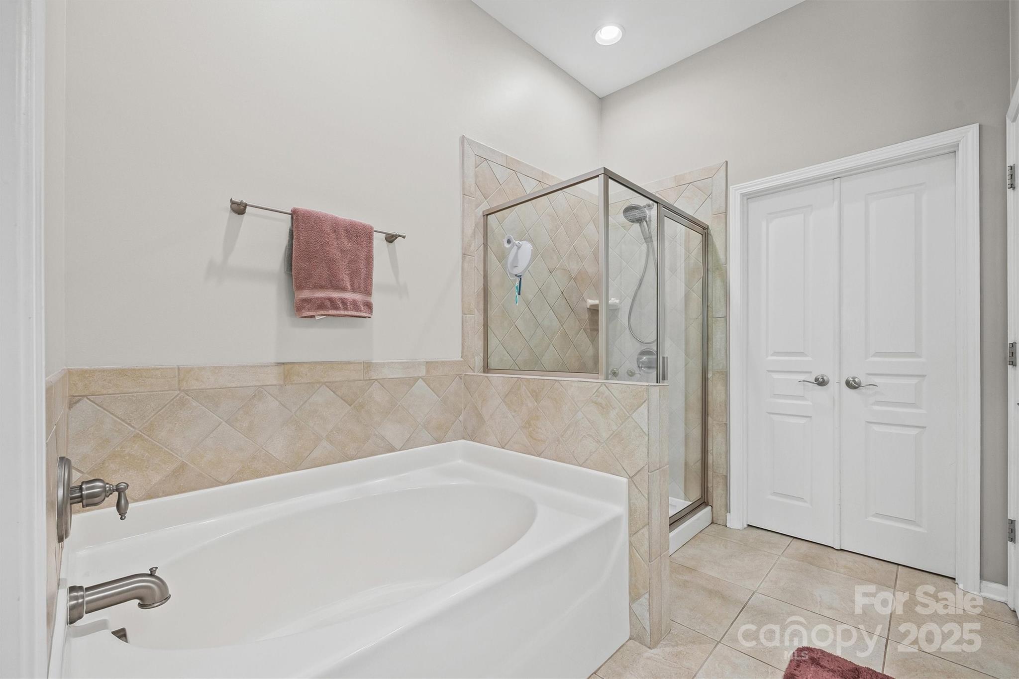 2090 Calloway Pines Drive Tega Cay, SC 29708 - Photo 13 of 38 a bathroom with a bathtub and a shower