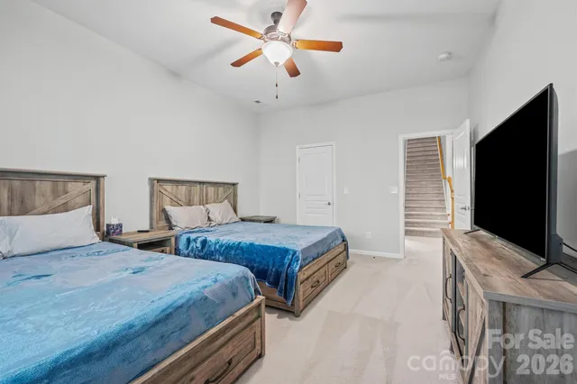 a bedroom with two bed and a flat screen tv