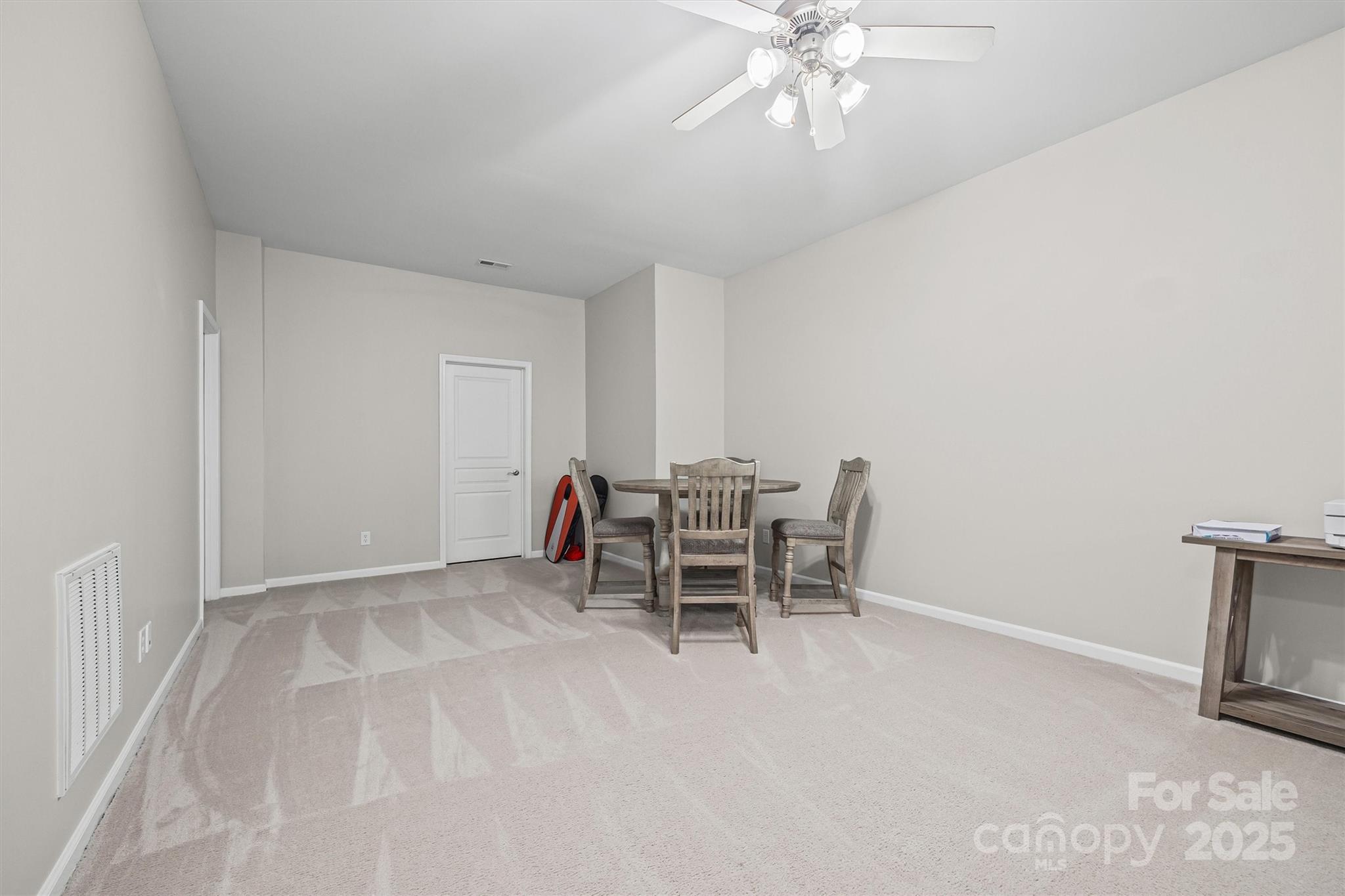 2090 Calloway Pines Drive Tega Cay, SC 29708 - Photo 18 of 38 a view of a livingroom with furniture and chandelier fan