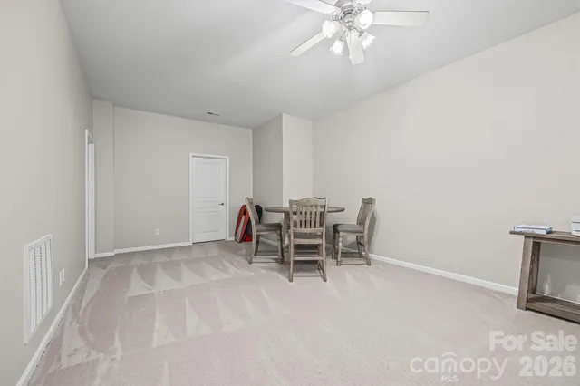 a view of a livingroom with furniture and chandelier fan